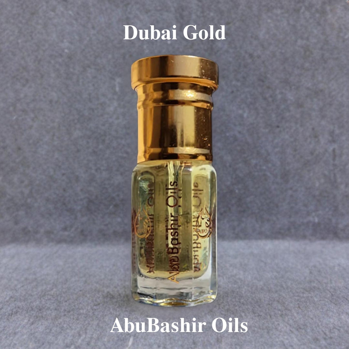 Dubai Gold fragrance oil by AbuBashir Oils with citrus, spice, floral, and amber notes in a small glass bottle with gold cap
