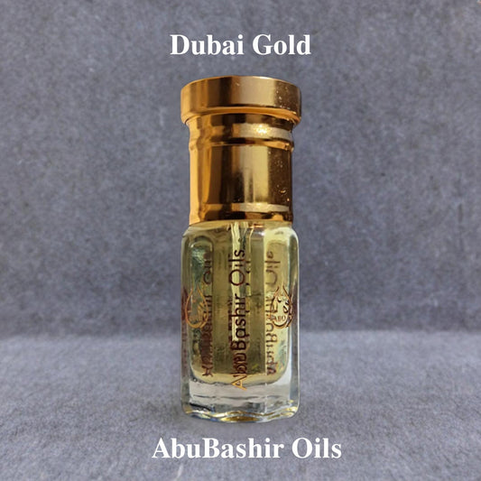 Dubai Gold fragrance oil by AbuBashir Oils with citrus, spice, floral, and amber notes in a small glass bottle with gold cap