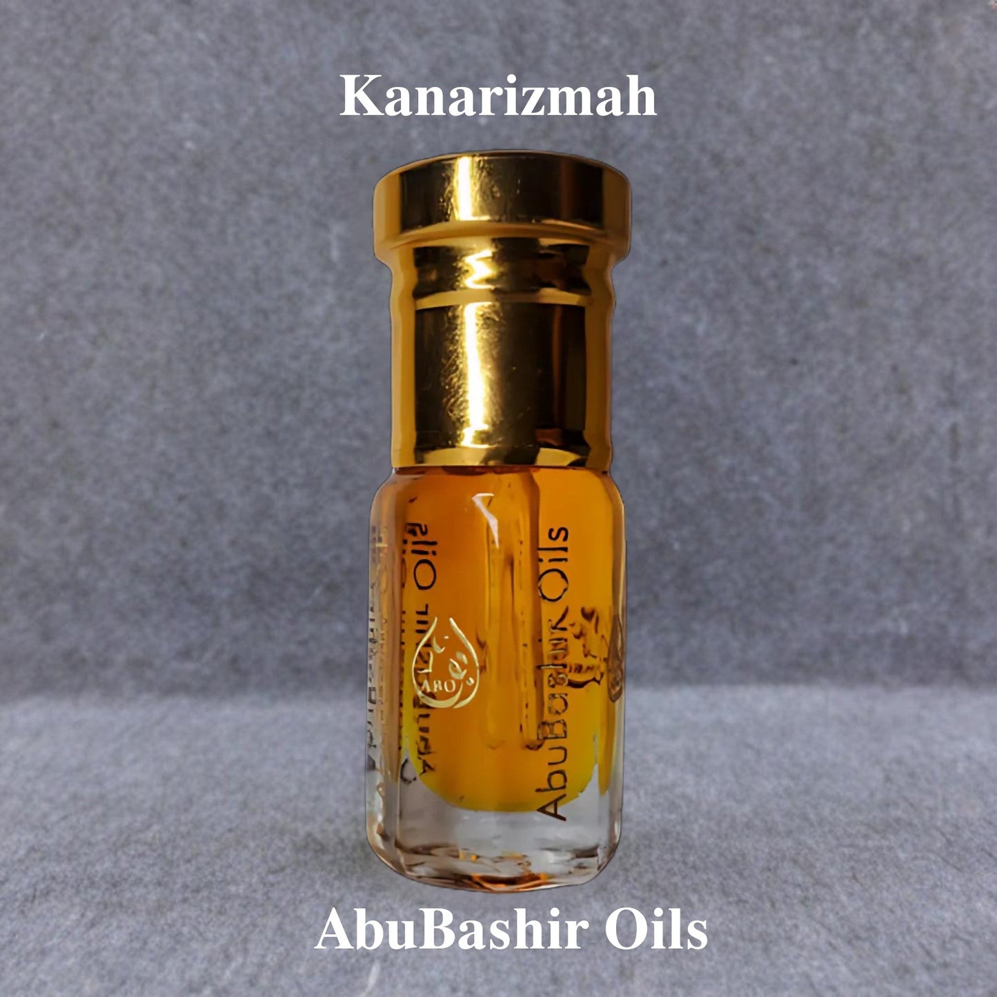 Kanarizmah fragrance oil by AbuBashir Oils with vibrant citrus and warm amber notes in a small glass bottle with a gold cap