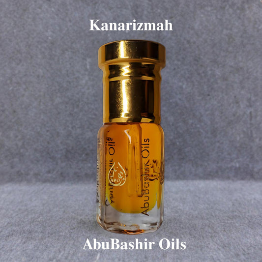Kanarizmah fragrance oil by AbuBashir Oils with vibrant citrus and warm amber notes in a small glass bottle with a gold cap